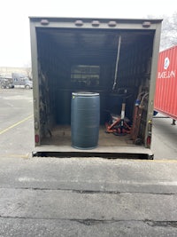 the back of a truck with a barrel in it