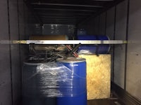 the back of a truck with several barrels in it