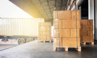 two wooden pallets in front of a truck in a warehouse