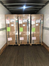 three boxes are sitting in the back of a truck